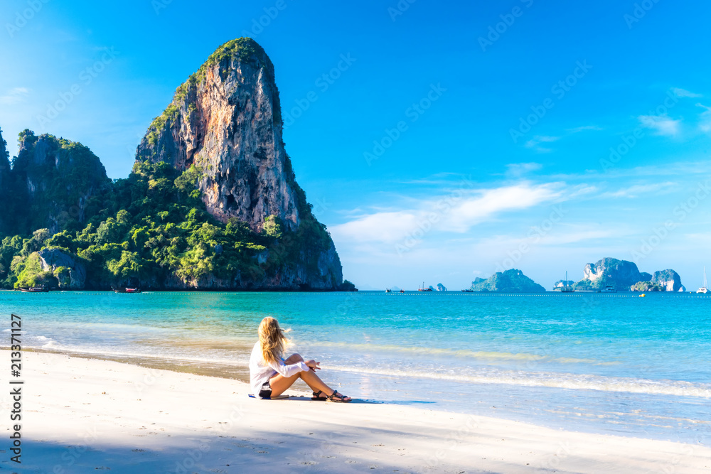 Woman resting on Railay beach Krabi Thailand. Asia