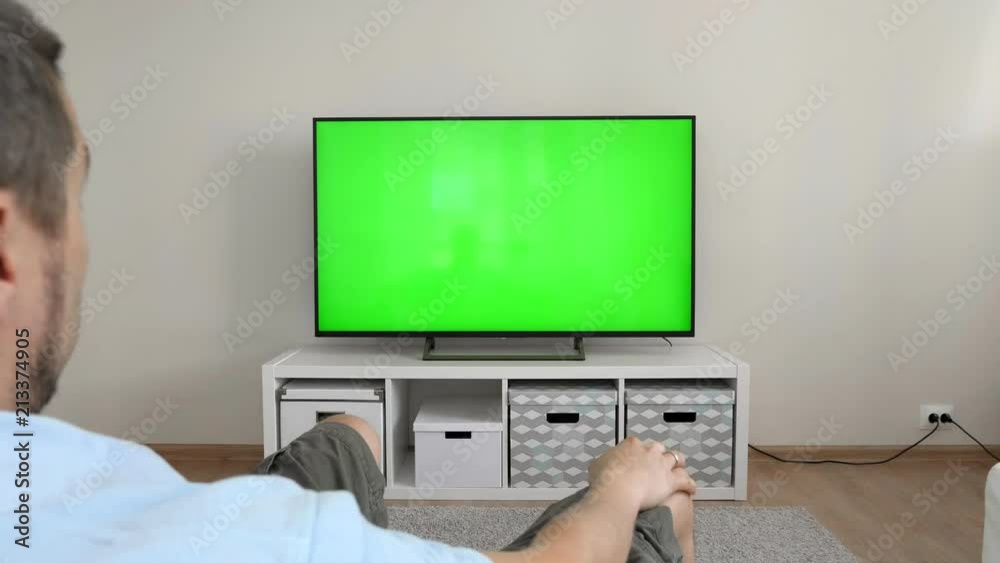 Man with joyful emotions watches football on tv Man with joyful emotions watches football on tv