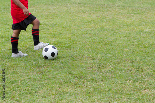 A boy playing soccer on the sports field