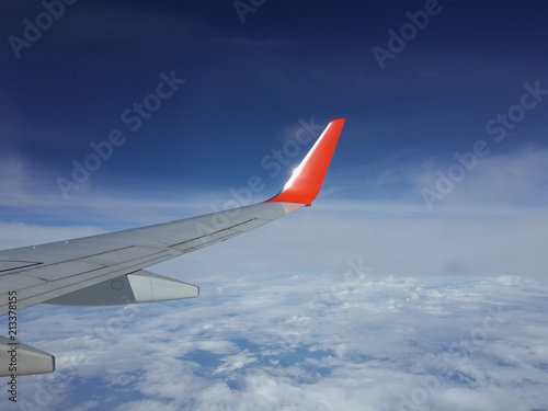 View of an airplane wing from window Seat flying above the clouds