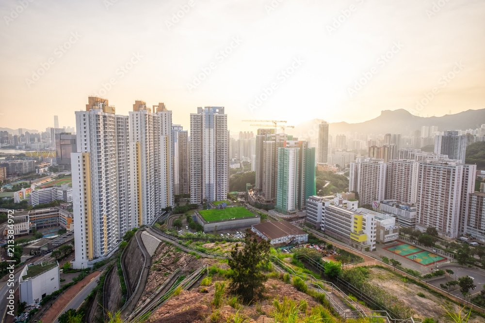Kowloon Residential Building and Urban Skyscrapers Under Mountains Lion Rock Summer Sunset Landscape with Dramatic Sky
