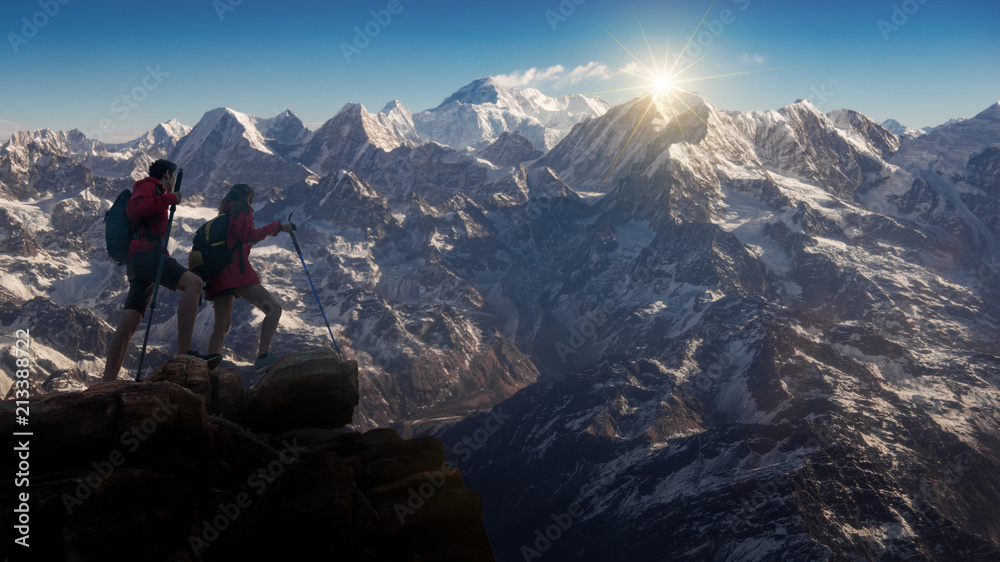 Hiking in Himalaya mountains, Hikers with backpacks relaxing on top of a mountain and enjoying the view of valley