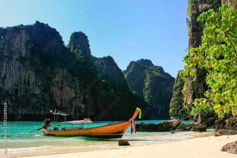 Longtail boat anchored by secluded beach on Phi Phi Leh Island, Krabi province, Thailand