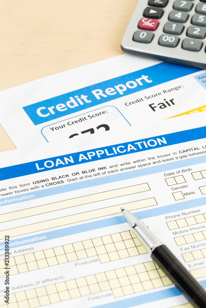 Loan application form fair credit score with calculator, and pen Loan application form fair credit score with calculator, and pen