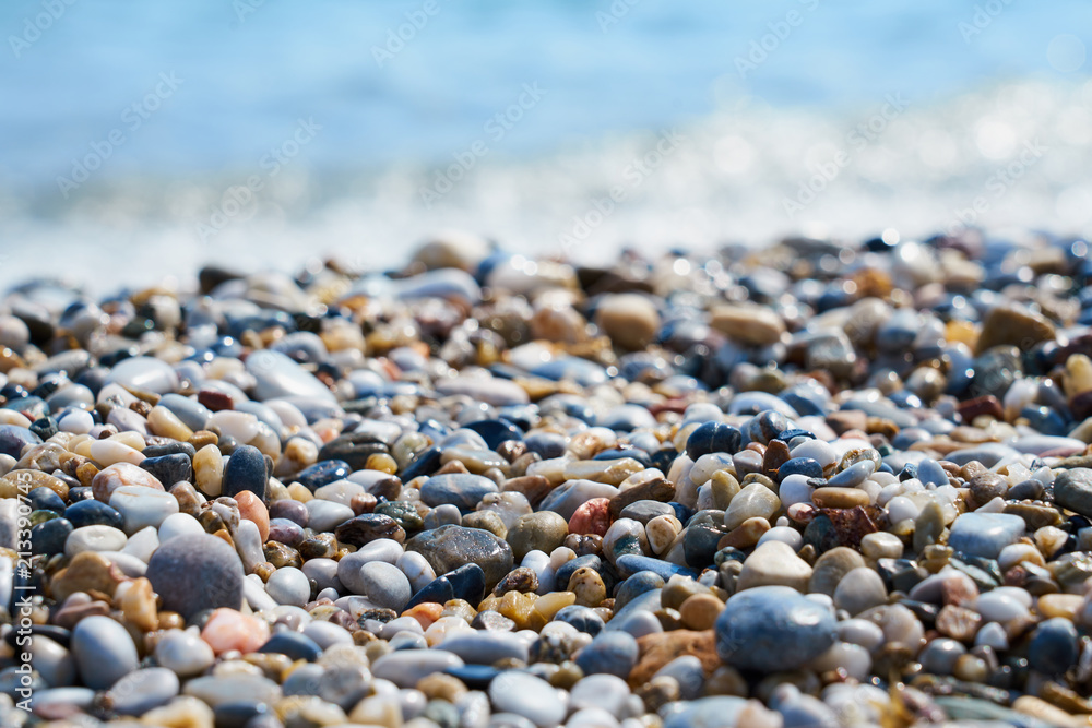 Pebble beach with blurred sea water on a background. Pebble beach with blurred sea water on a background.