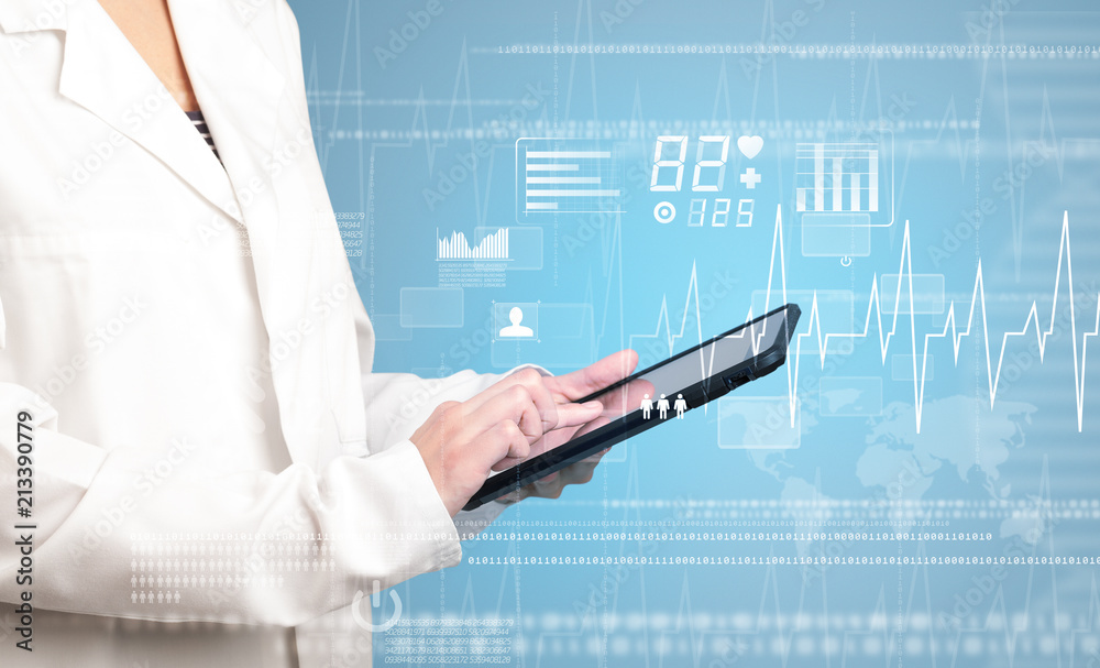 Female doctor holding tablet with blue background and heart related charts Female doctor holding tablet with blue background and heart related charts