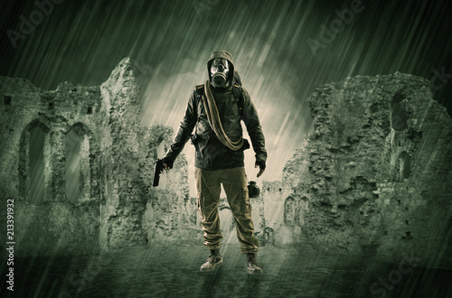 Hazard, menace man in a ruined crumbly building with arms on his hand
