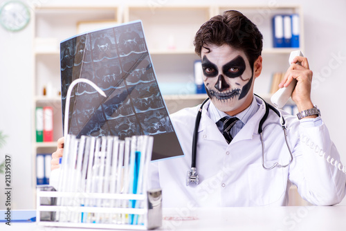 Scary monster doctor working in lab photo