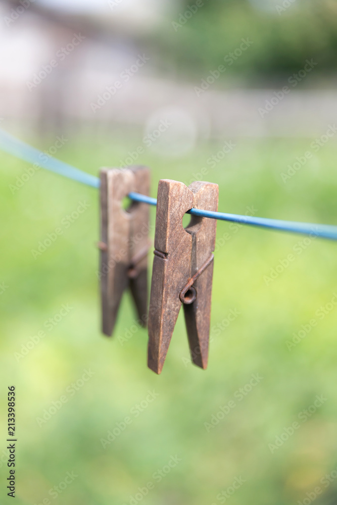Wooden clothes pins on a string outside Wooden clothes pins on a string outside