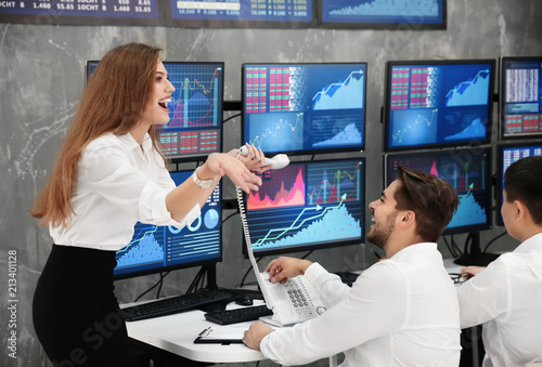 Fotografija Excited stock traders working in office