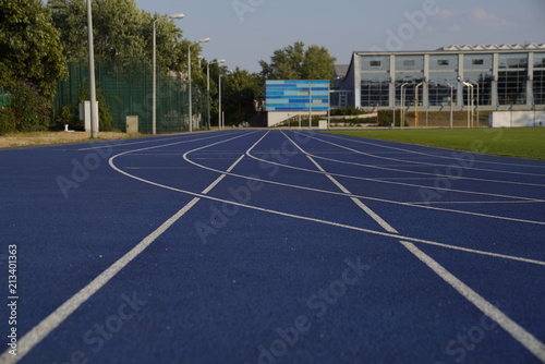 Blue outdoor stadium running track with white dividing lines