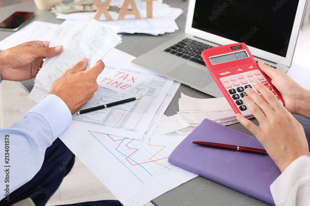 Tax accountants working with documents at table Tax accountants working with documents at table