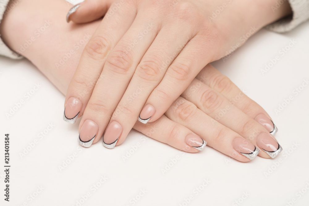 Hands with manicured nails covered with pink nail polish on fur background Hands with manicured nails covered with pink nail polish on fur background