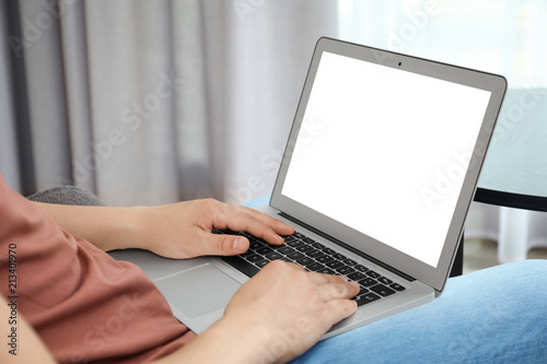 Man in casual clothes with laptop indoors