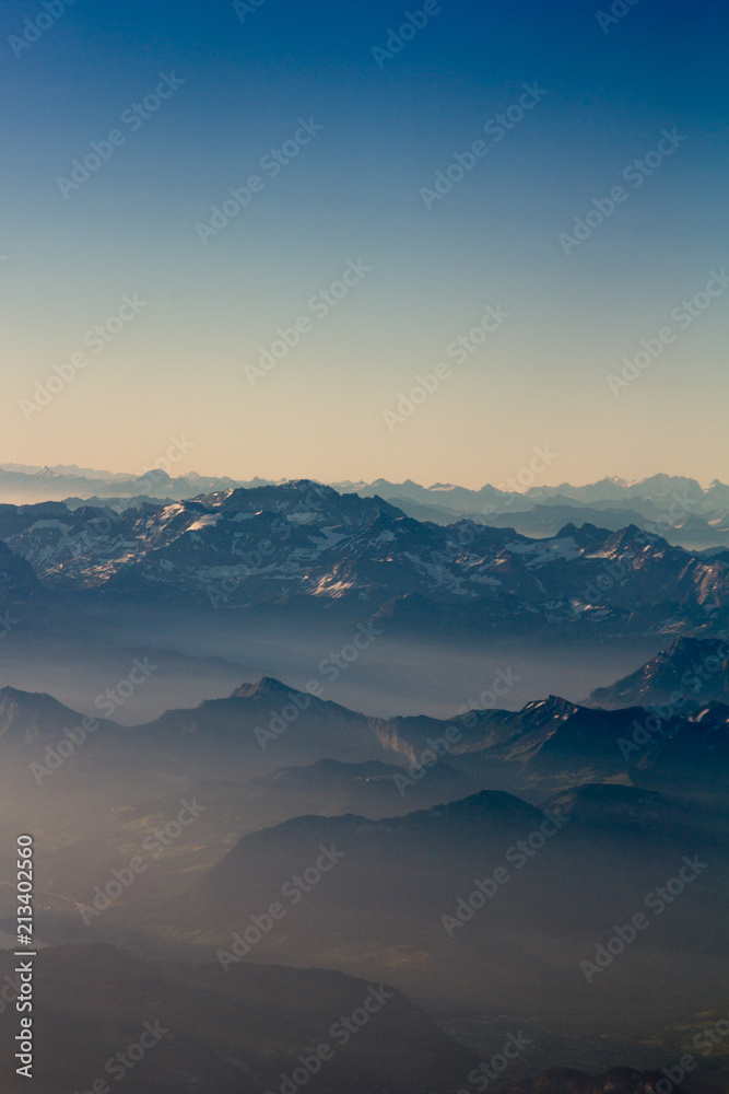 Alps mountains from range aerial view at sunrise. Switzerland. Filtered image:cross processed vintage effect. 