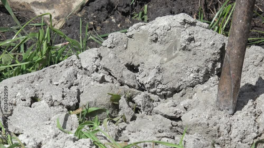 chisel breaking concrete block on construction site