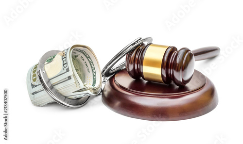 Judge's gavel, handcuffs and money on white.