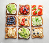 Tasty toast bread with fruits, berries and vegetables on light background