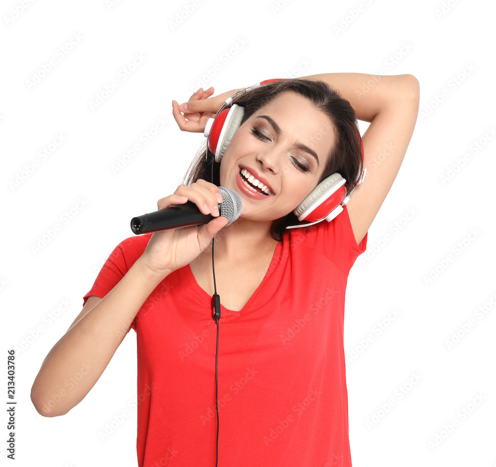 Young woman singing into microphone on white background. Christmas music Young woman singing into microphone on white background. Christmas music