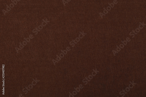 Dark brown felt background texture close up