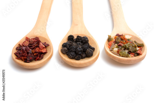 wooden spoon filled with various spices isolated on the white