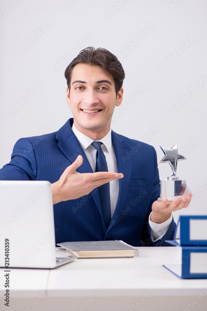 Young handsome businessman employee working in office at desk Young handsome businessman employee working in office at desk