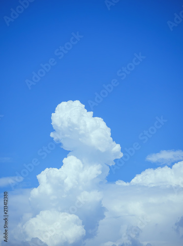 White cumulonimbus clouds of intricate shape on a blue sky. © sablinstanislav