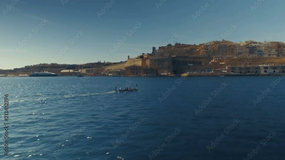 Low Aerial shot orbiting around a maltese Luzzu Low Aerial shot orbiting around a maltese Luzzu
