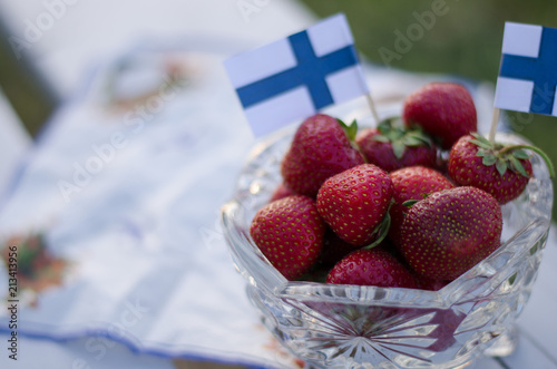 Strawberries in a bowl of glass with finland flag