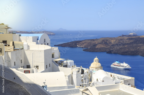 Thira town cityscape during daytime in Santorini, Greece with cruise ship on sea
