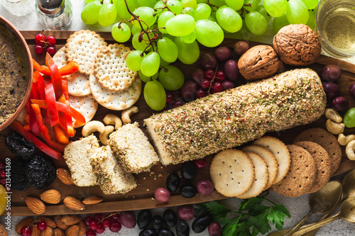 raw vegan cheese from cashew nuts on a table with appetizer. healthy snacks for celebrating together