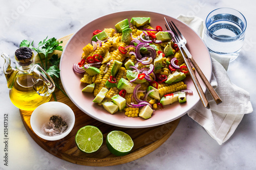 grilled corn , avocado salad with blue onion and chili pepper. healthy summer breakfast or lunch