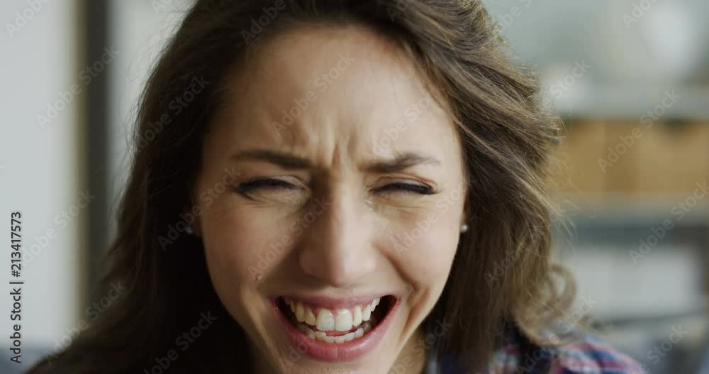 Close up of the young beatiful woman crying and being all in tears. Portrait. Indoor. Close up of the young beatiful woman crying and being all in tears. Portrait. Indoor.