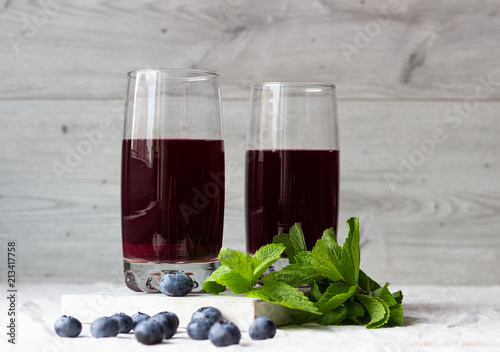 Summer blueberry cold drink (juice, cocktail, fruit tea) with mint and fresh blueberries. Cold refreshing beverage.