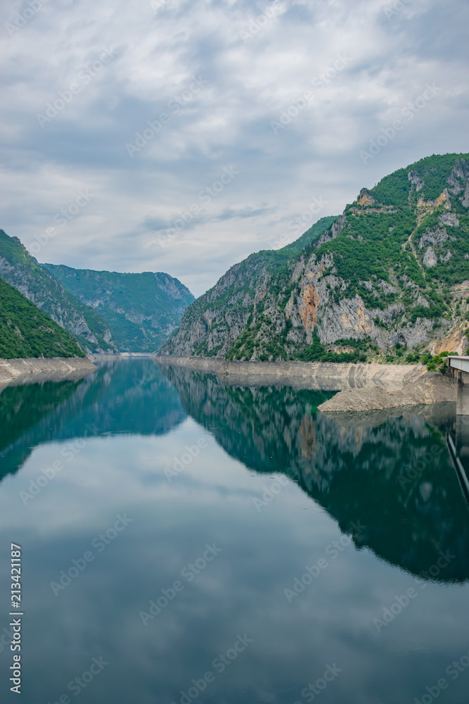 Fototapeta premium The picturesque turquoise lake is among the high mountains.
