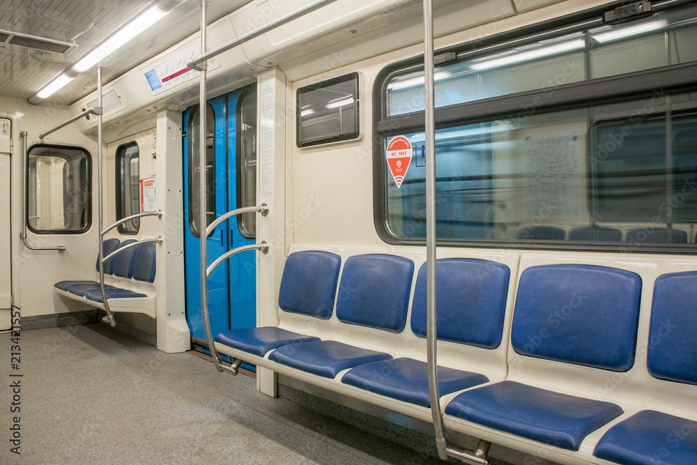 View of bright empty interior of modern subway train car. Contemporary