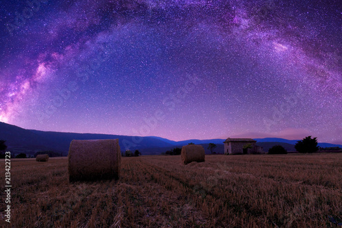 The summer Milky Way over  farmland and straw bales in Provence