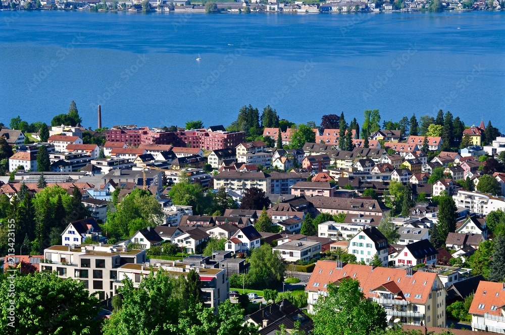 Stadt Kilchberg am Zürichsee im Kanton Zürich. Blick auf die Hausdächer, den See und die Schokoladefabrik