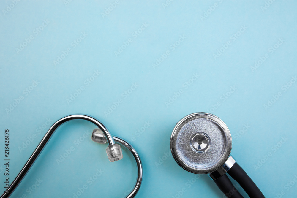 Medical pressure gauge and stethoscope on light blue background, for heart listening, isolated place for text - obrazy, fototapety, plakaty 