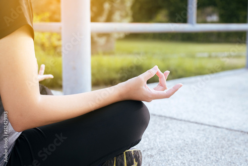 Healthy and lifestyle concept,Woman sitting practicing doing yoga exercise,workout after waking up at garden,Selective focus