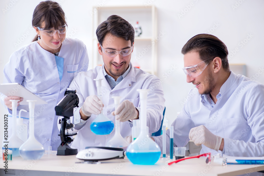 Team of chemists working in the lab Team of chemists working in the lab