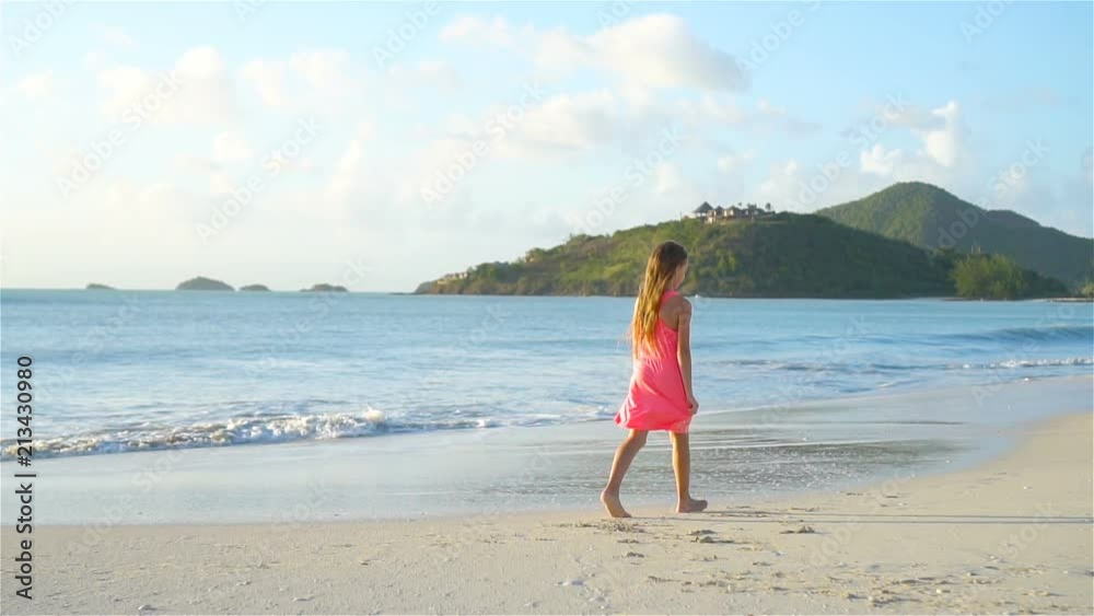 Sihouette of little girl walking on the beach at sunset. Sihouette of little girl walking on the beach at sunset.