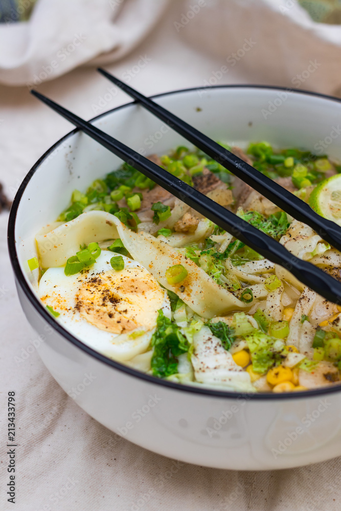 Ramen noodle soup with egg, corn and meat in bowl. Asian Thai traditional authentic food with vegetables served in cafe or restaurant Ramen noodle soup with egg, corn and meat in bowl. Asian Thai traditional authentic food with vegetables served in cafe or restaurant