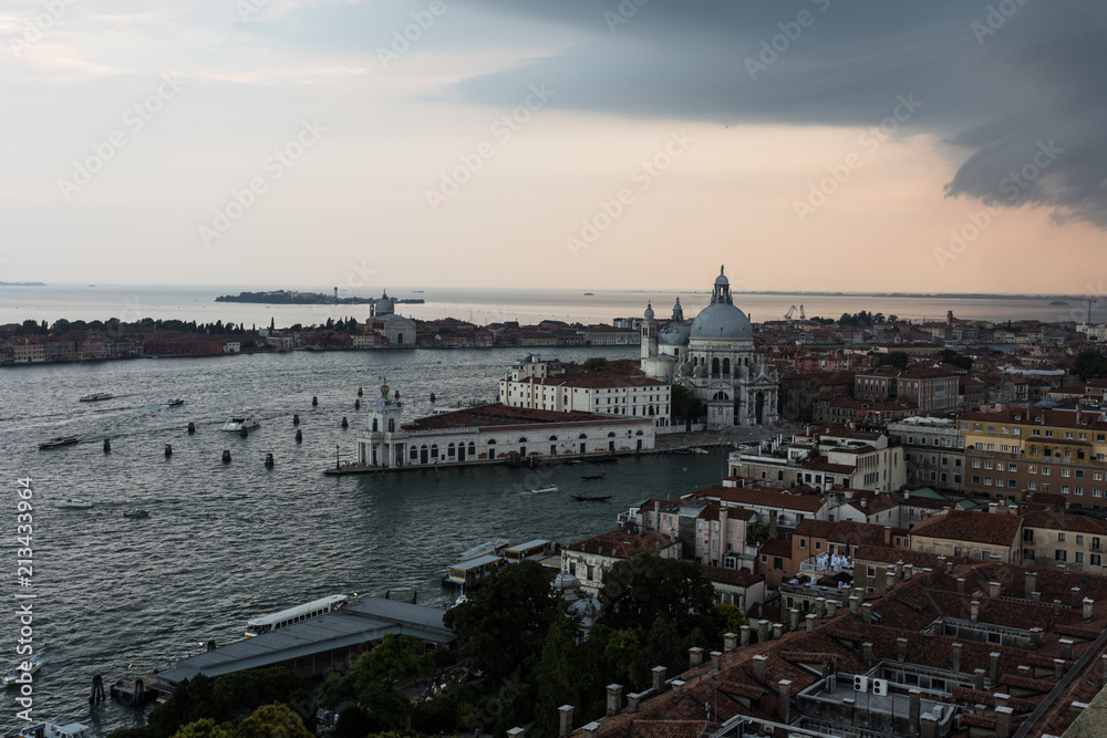 Fototapeta premium Threatening sky over the Grand Canal and the famous basilica di santa maria della salute in Venice old town in north italy.