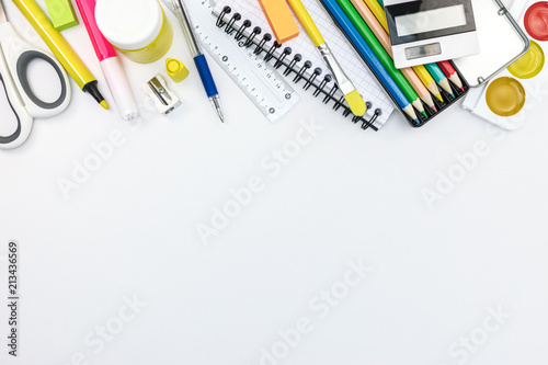school stationary and tools for kids. pencils, paints, notebooks on white background, flat view