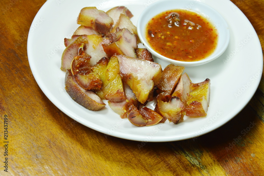 roasted pork ear slice dipping with spicy sauce on plate roasted pork ear slice dipping with spicy sauce on plate