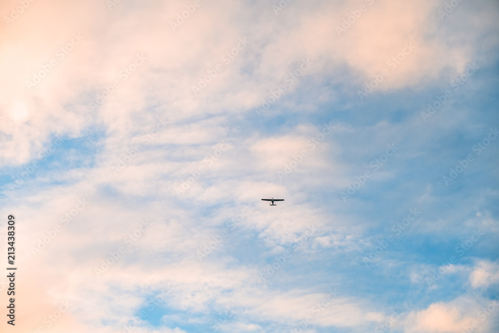Airplane flying over the blue sky. cloudy and sunset.
