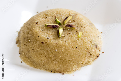 Plain or kesar flavoured Semolina Halwa / Sooji ka Halwa or sweet Rava Sheera or shira - Indian festival sweet made of semolina milk saffron nuts and Ghee photo