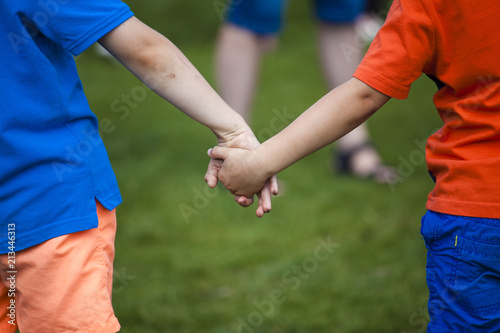 Two children hold hands