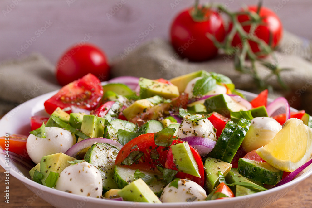 Avocado, tomato, cucumber salad with mozzarella cheese Avocado, tomato, cucumber salad with mozzarella cheese